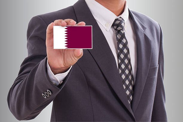 a man in a suit holding a card
